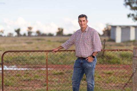 Ed Wade stands leaning on a gate